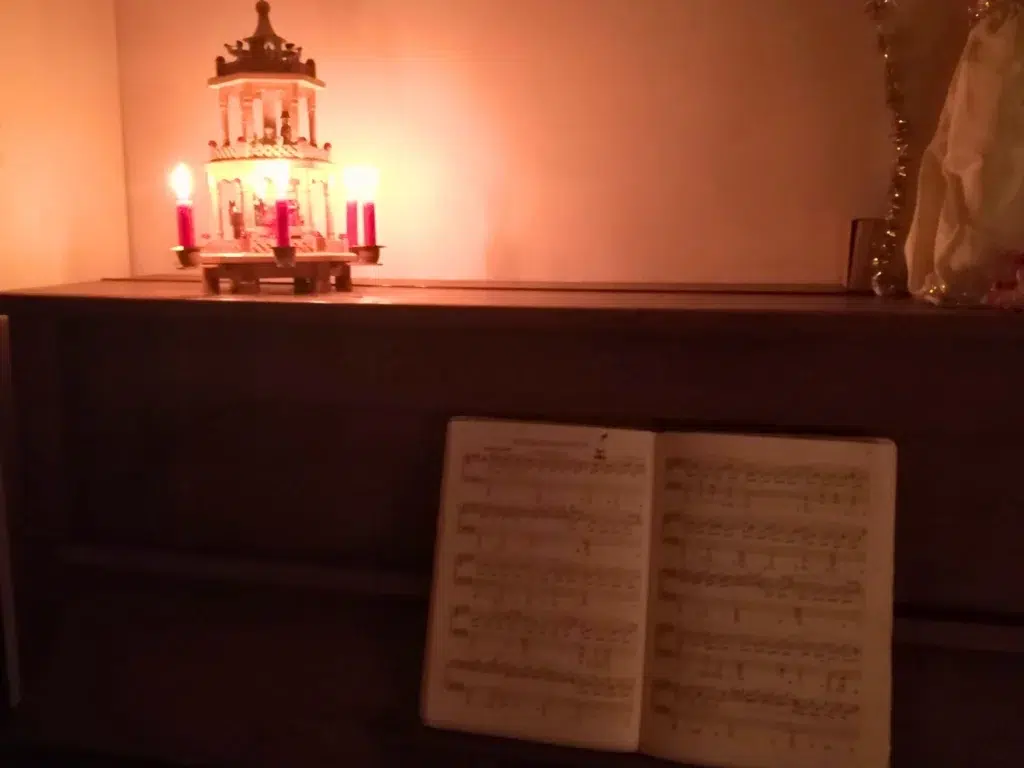 Kerzenpyramide auf einem Klavier mit aufgeschlagene Noten